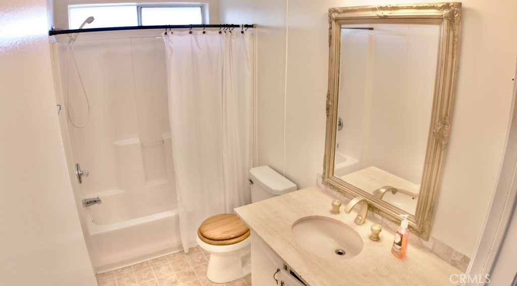 8130 Camp Rock Road Lucerne Valley, CA 92356 - Photo 12 of 14 a bathroom with a granite countertop sink toilet and shower