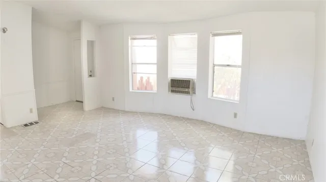 a view of a kitchen with white cabinets and white appliances