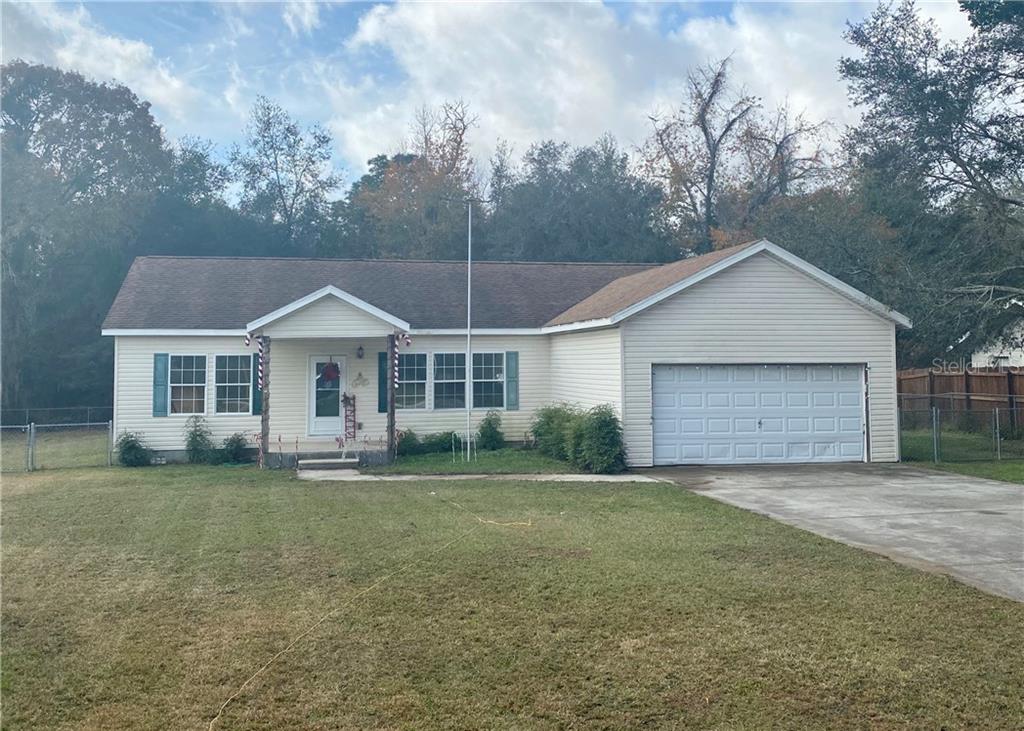 8 Cedar Way Ocala, FL 34472 - Photo 1 of 1 a front view of a house with a garden and yard