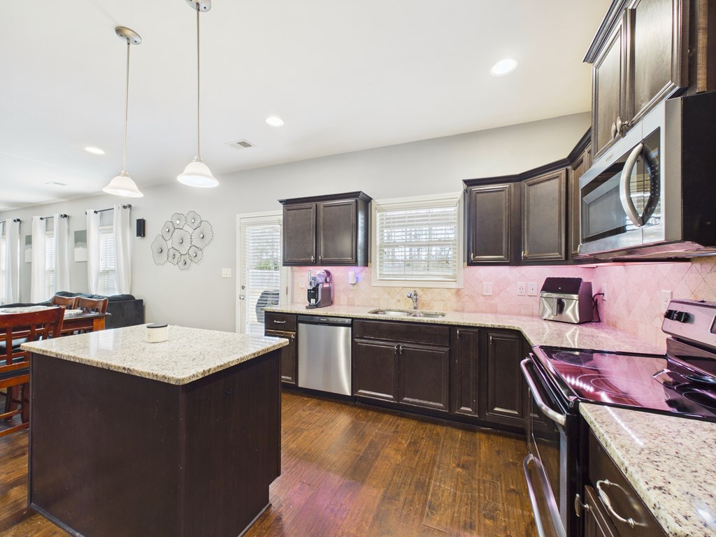 783 Sweetbay Parkway Hamilton, GA 31811 - Photo 14 of 46 a kitchen with stainless steel appliances granite countertop a sink stove and refrigerator