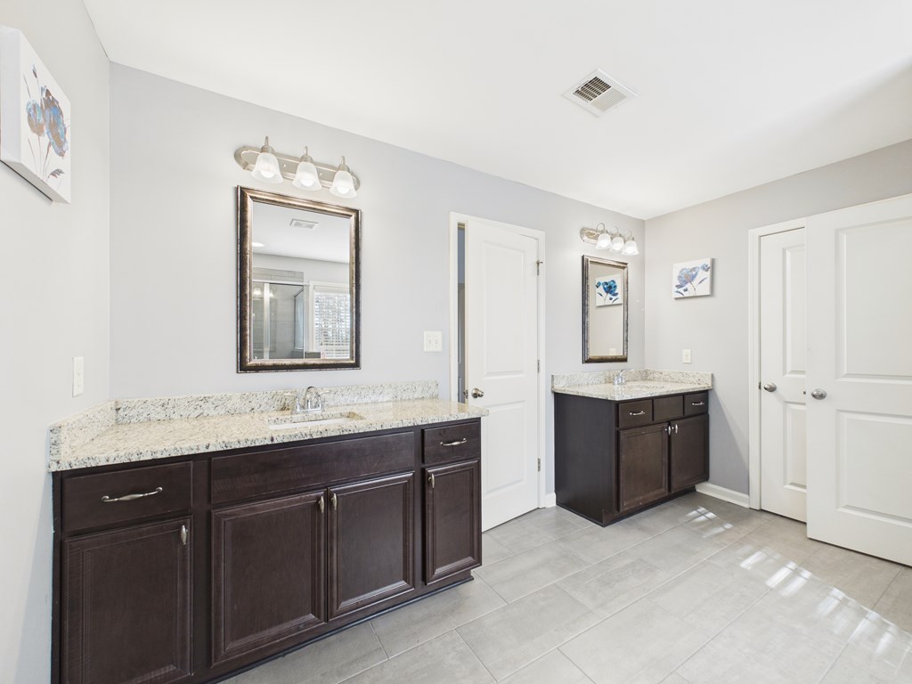 783 Sweetbay Parkway Hamilton, GA 31811 - Photo 24 of 46 a spacious bathroom with a granite countertop double vanity sink mirror and bathtub