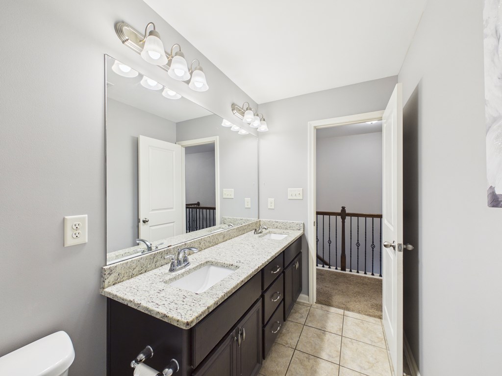 783 Sweetbay Parkway Hamilton, GA 31811 - Photo 26 of 46 a bathroom with a granite countertop sink a large mirror and a toilet
