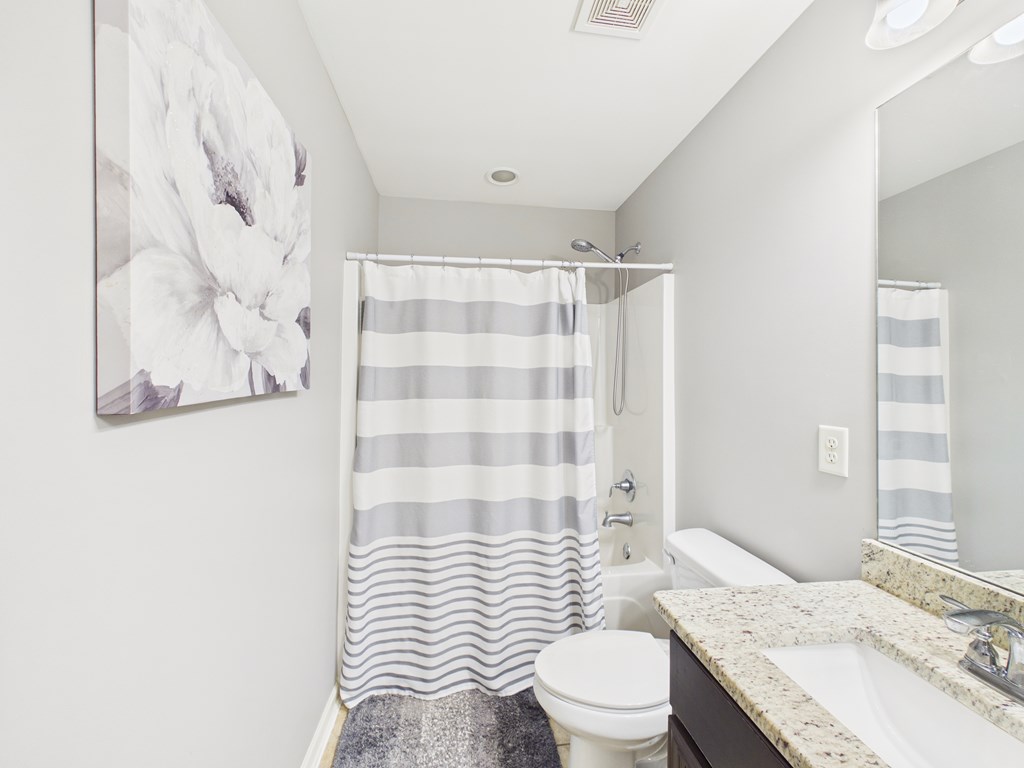 783 Sweetbay Parkway Hamilton, GA 31811 - Photo 27 of 46 a bathroom with a sink a toilet and shower curtain