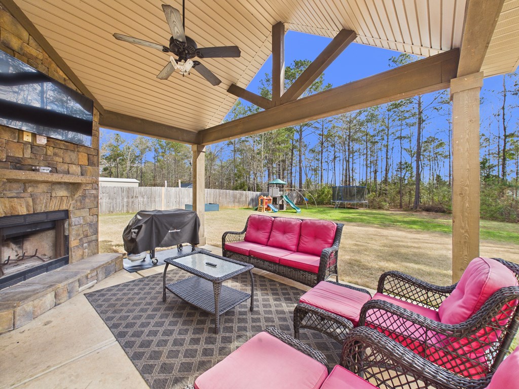783 Sweetbay Parkway Hamilton, GA 31811 - Photo 39 of 46 a outdoor space with patio the couches and a fireplace with the potted plants