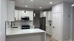 a kitchen with stainless steel appliances a refrigerator sink and stove