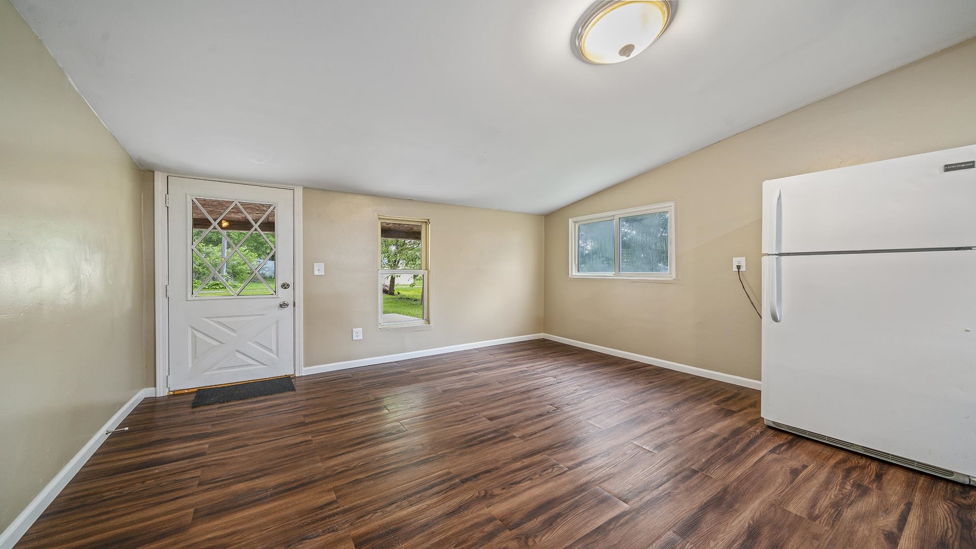 1122 1st Avenue Rochelle, IL 61068 - Photo 3 of 28 a view of an empty room with wooden floor and a window