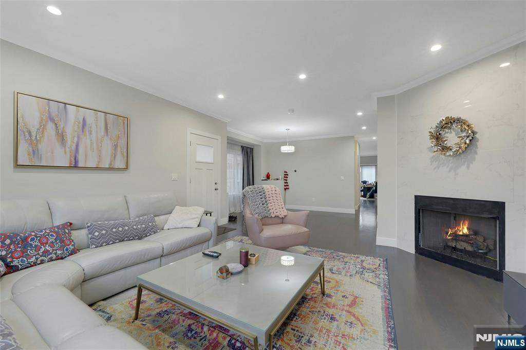 229 6th Street, Unit A Fairview, NJ 07022 - Photo 4 of 35 a living room with furniture and a fireplace