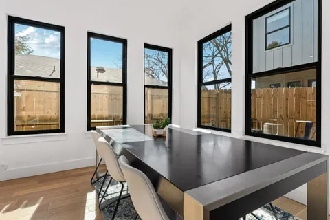 a kitchen with stainless steel appliances granite countertop a sink a stove and a wooden floors