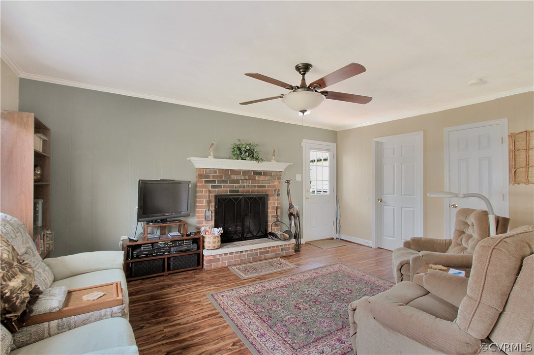 10009 Wycliff Road Chesterfield, VA 23236 - Photo 7 of 24 a living room with furniture a fireplace and a flat screen tv
