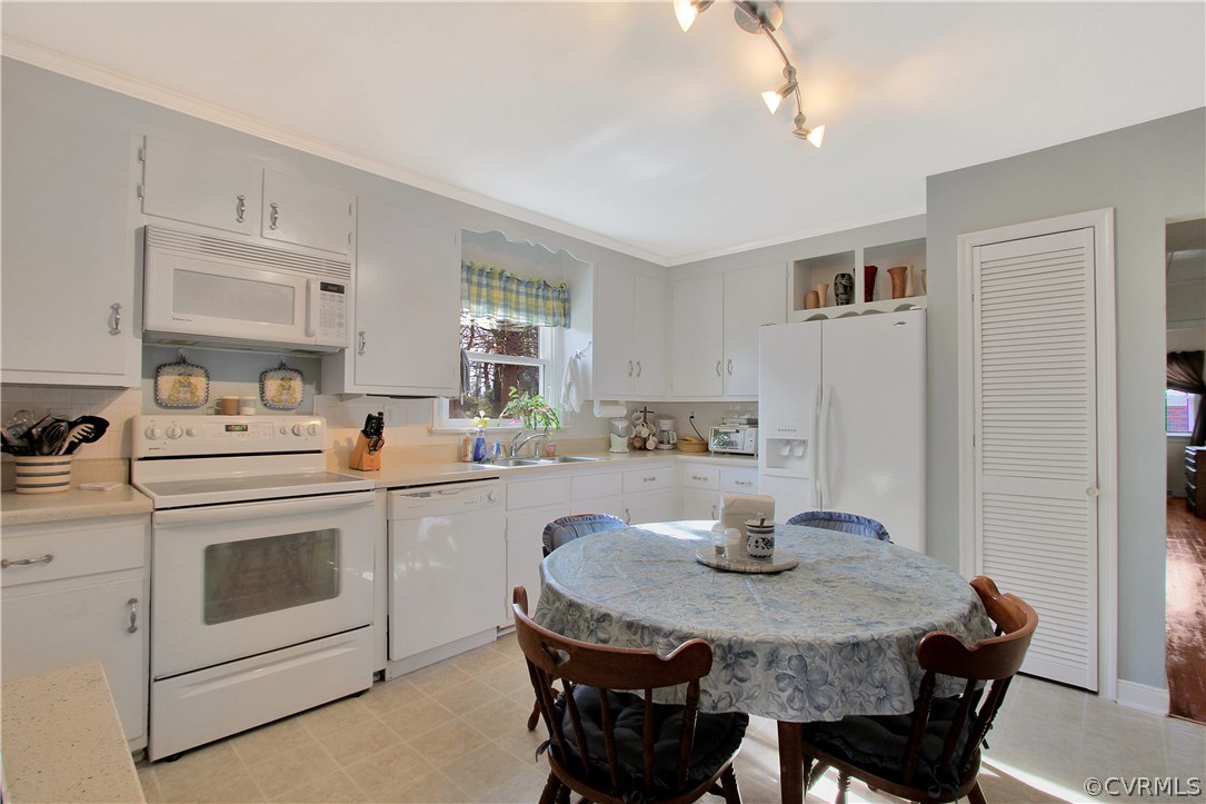 10009 Wycliff Road Chesterfield, VA 23236 - Photo 9 of 24 a kitchen with a stove a sink dining table and chairs