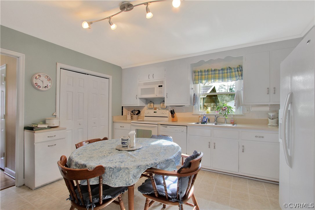 10009 Wycliff Road Chesterfield, VA 23236 - Photo 10 of 24 a kitchen with granite countertop white cabinets and chairs