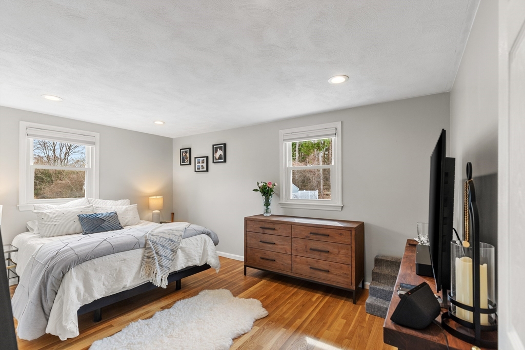 16 Bear Hill Road Billerica, MA 01821 - Photo 11 of 28 a bedroom with a bed and a dresser next to a window