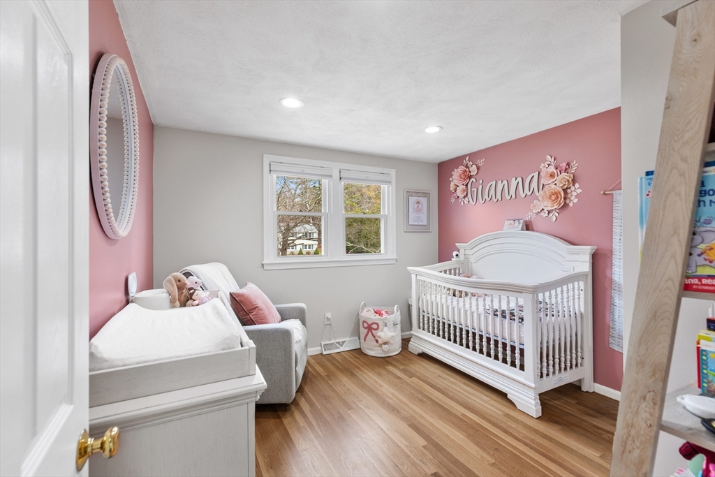 16 Bear Hill Road Billerica, MA 01821 - Photo 12 of 28 a bedroom with a bed and wooden floor