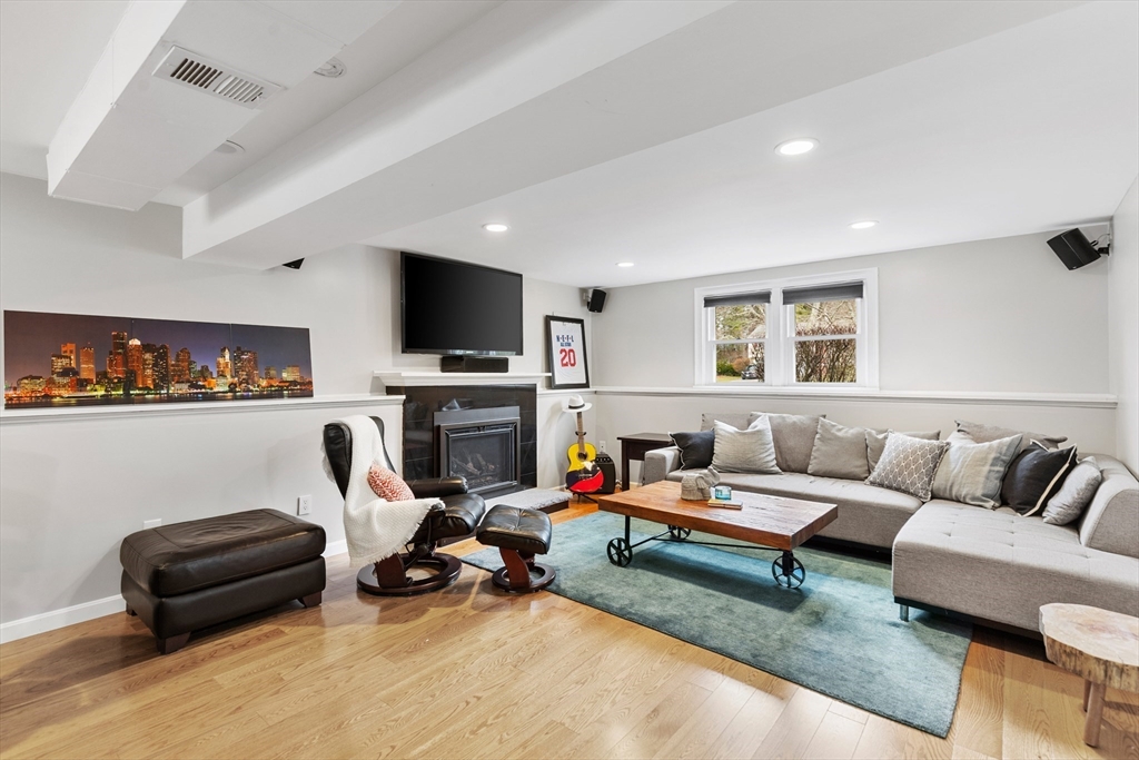 16 Bear Hill Road Billerica, MA 01821 - Photo 15 of 28 a living room with furniture a fireplace and a flat screen tv