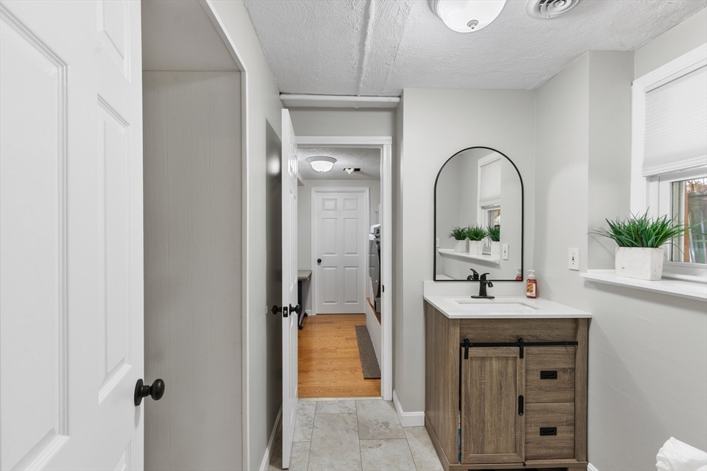 16 Bear Hill Road Billerica, MA 01821 - Photo 19 of 28 a en suite bathroom with a sink and a mirror