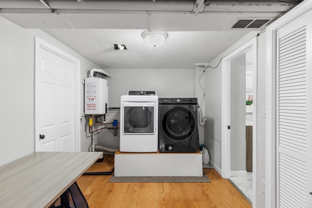 16 Bear Hill Road Billerica, MA 01821 - Photo 21 of 28 a view of a storage and utility room with washer and dryer