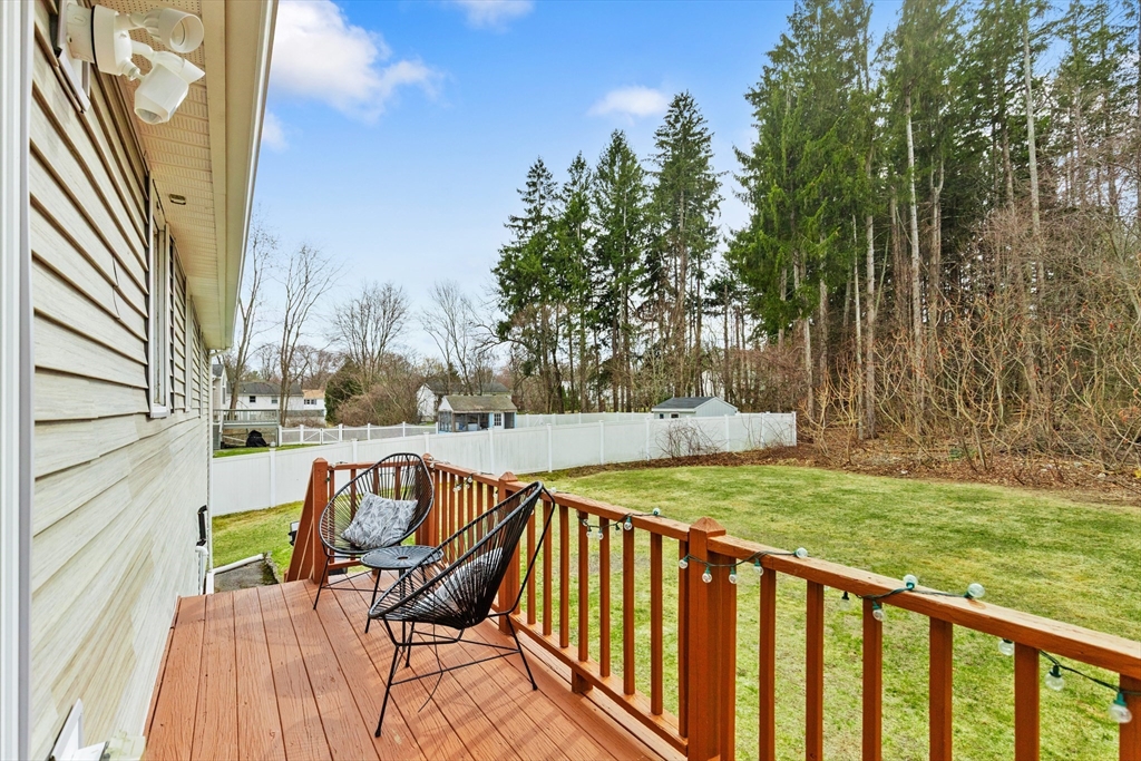 16 Bear Hill Road Billerica, MA 01821 - Photo 25 of 28 a view of a patio with a table chairs and a yard