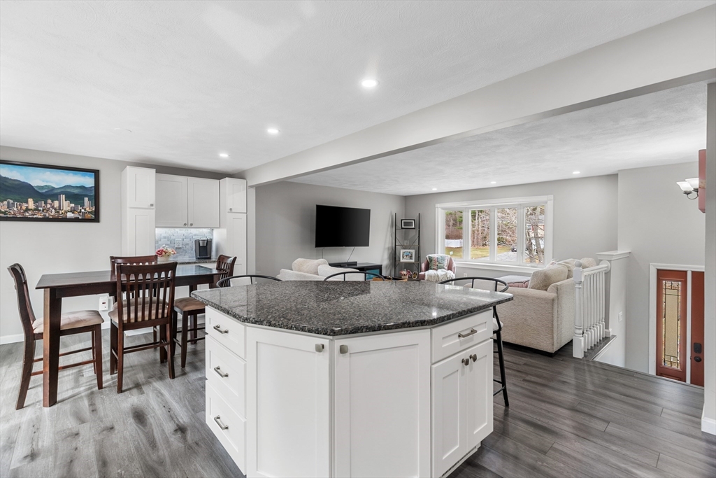 16 Bear Hill Road Billerica, MA 01821 - Photo 8 of 28 a view of a kitchen area with furniture and wooden floor