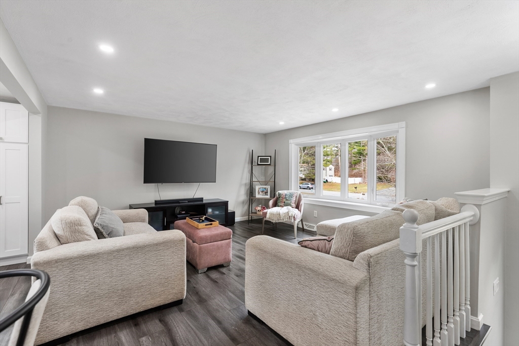 16 Bear Hill Road Billerica, MA 01821 - Photo 10 of 28 a living room with furniture and a flat screen tv