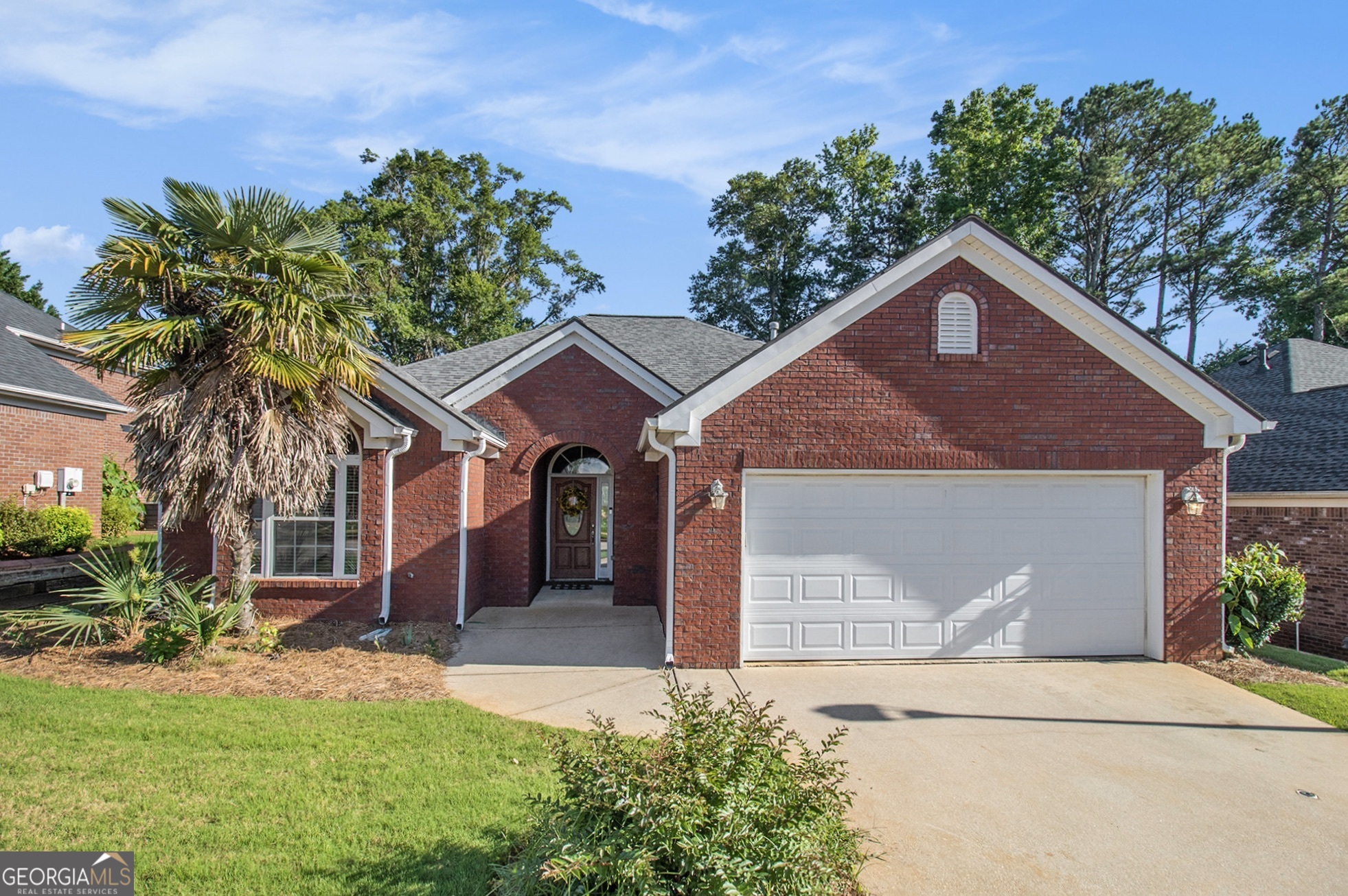 a front view of a house with a yard and garage