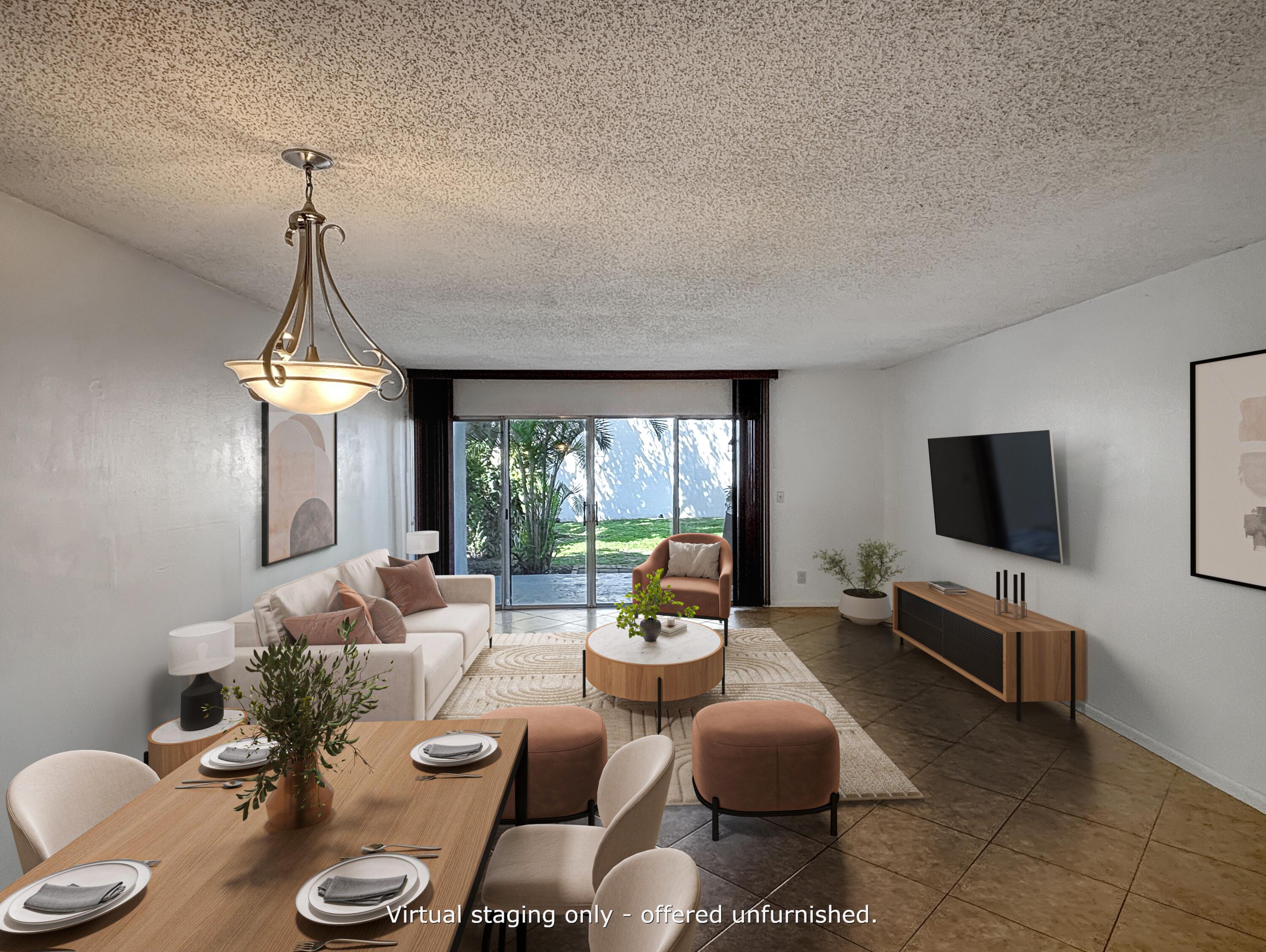 a living room with furniture a flat screen tv and a large window