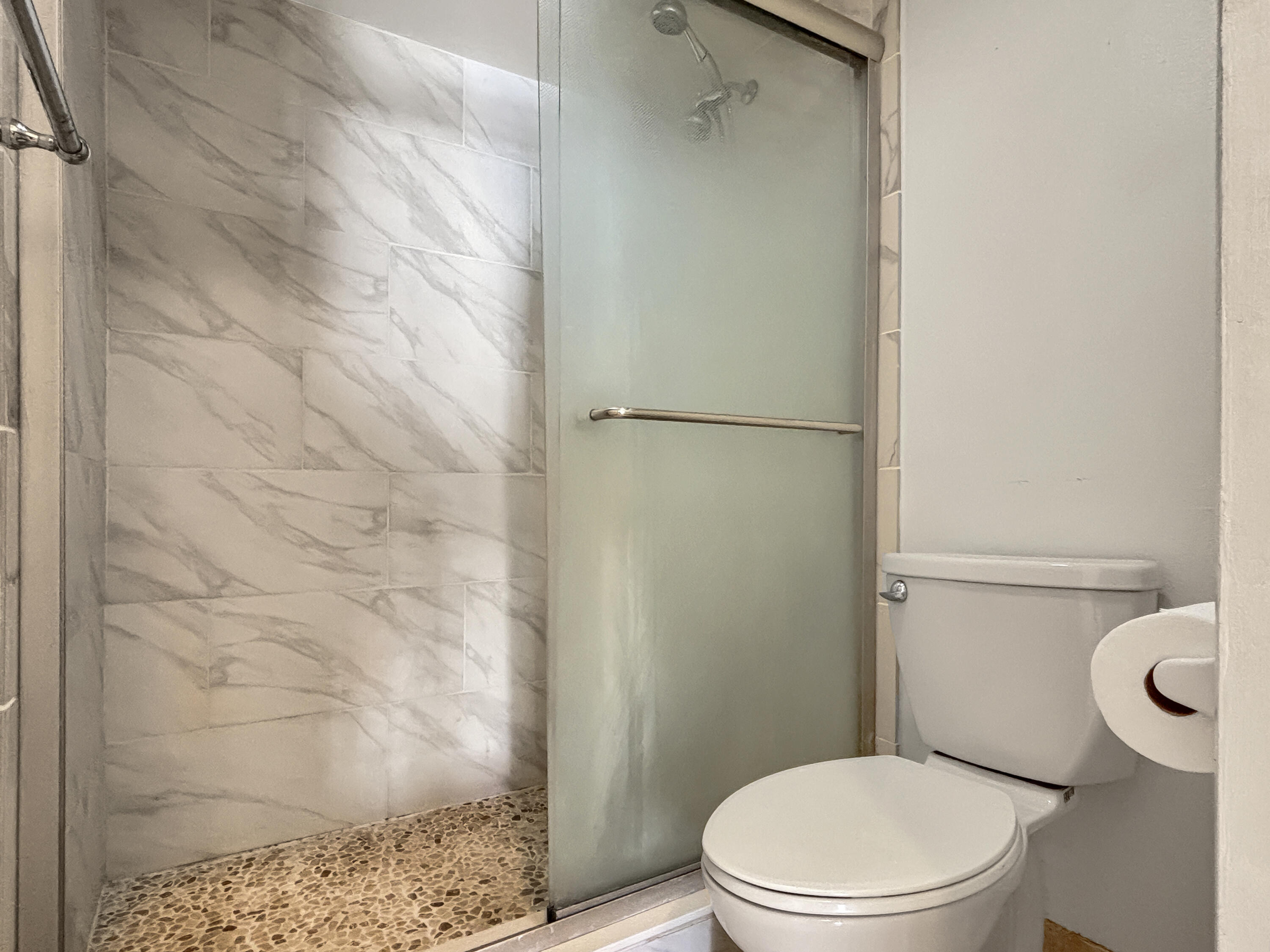 390 Golfview Road, Unit I North Palm Beach, FL 33408 - Photo 14 of 34 a white toilet sitting next to a shower