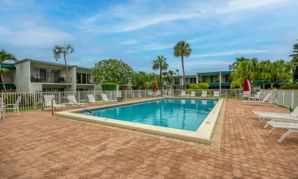 a view of swimming pool with a garden and trees