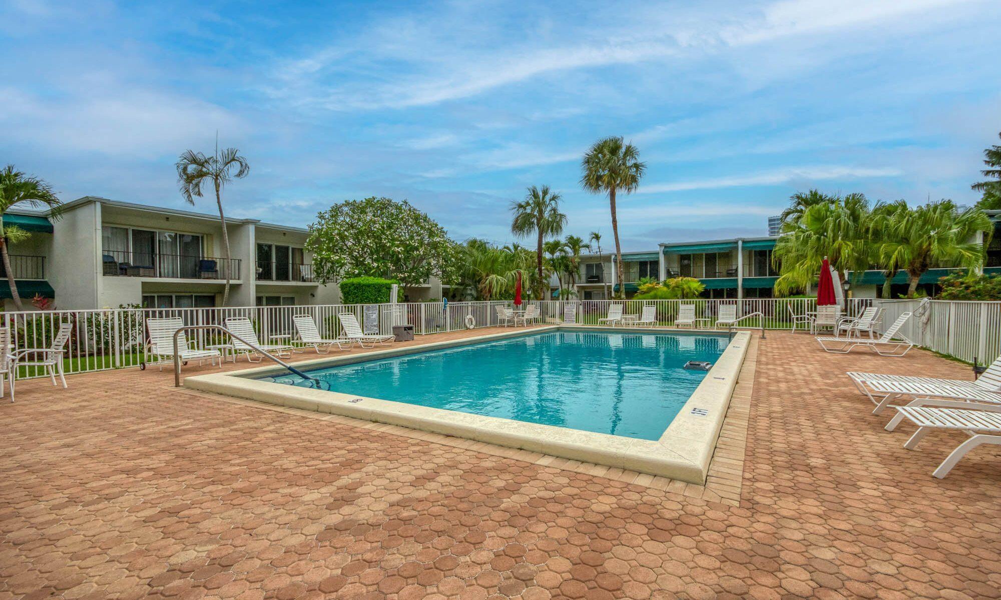 390 Golfview Road, Unit I North Palm Beach, FL 33408 - Photo 27 of 34 a view of a swimming pool with a lounge chairs