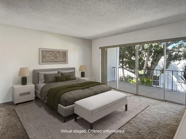 a bedroom with a bed and large window