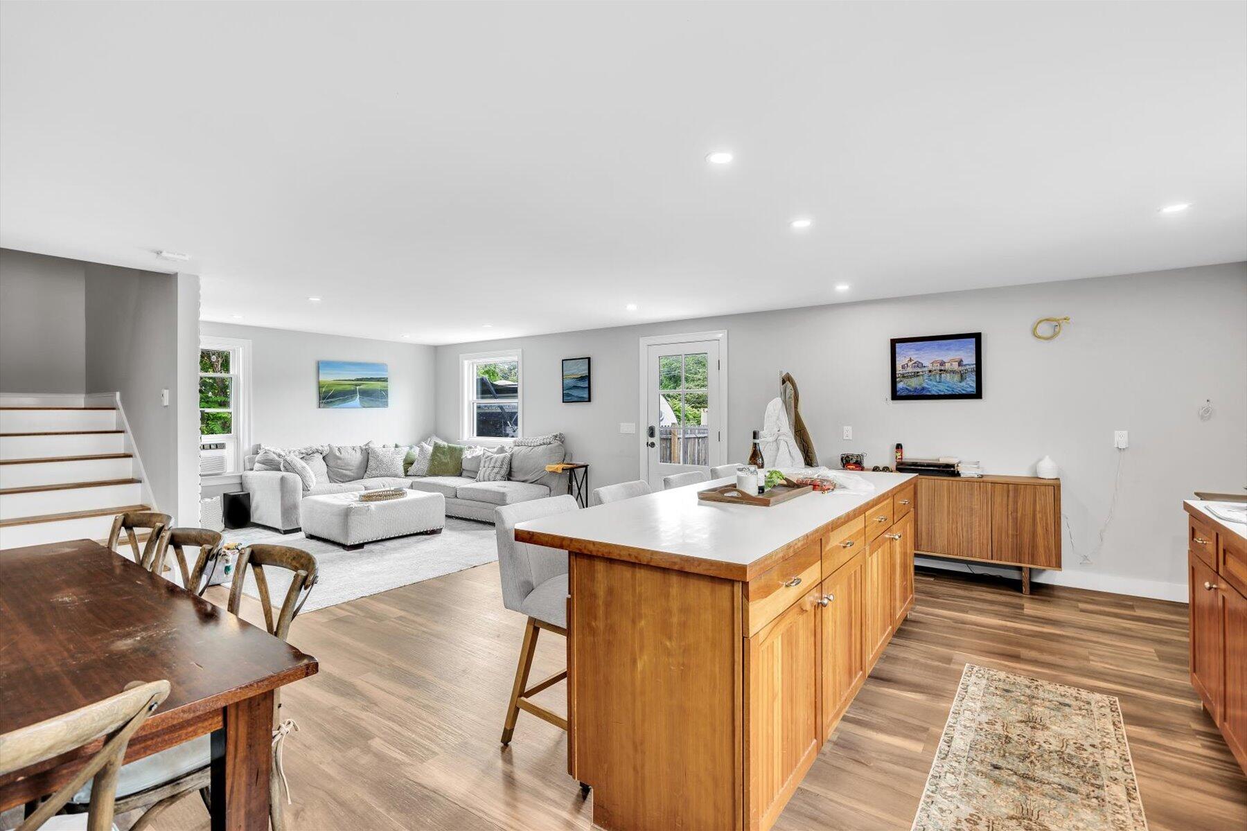1562 State Hwy Route Eastham, MA 02642 - Photo 19 of 31 a living room with kitchen island furniture and a table