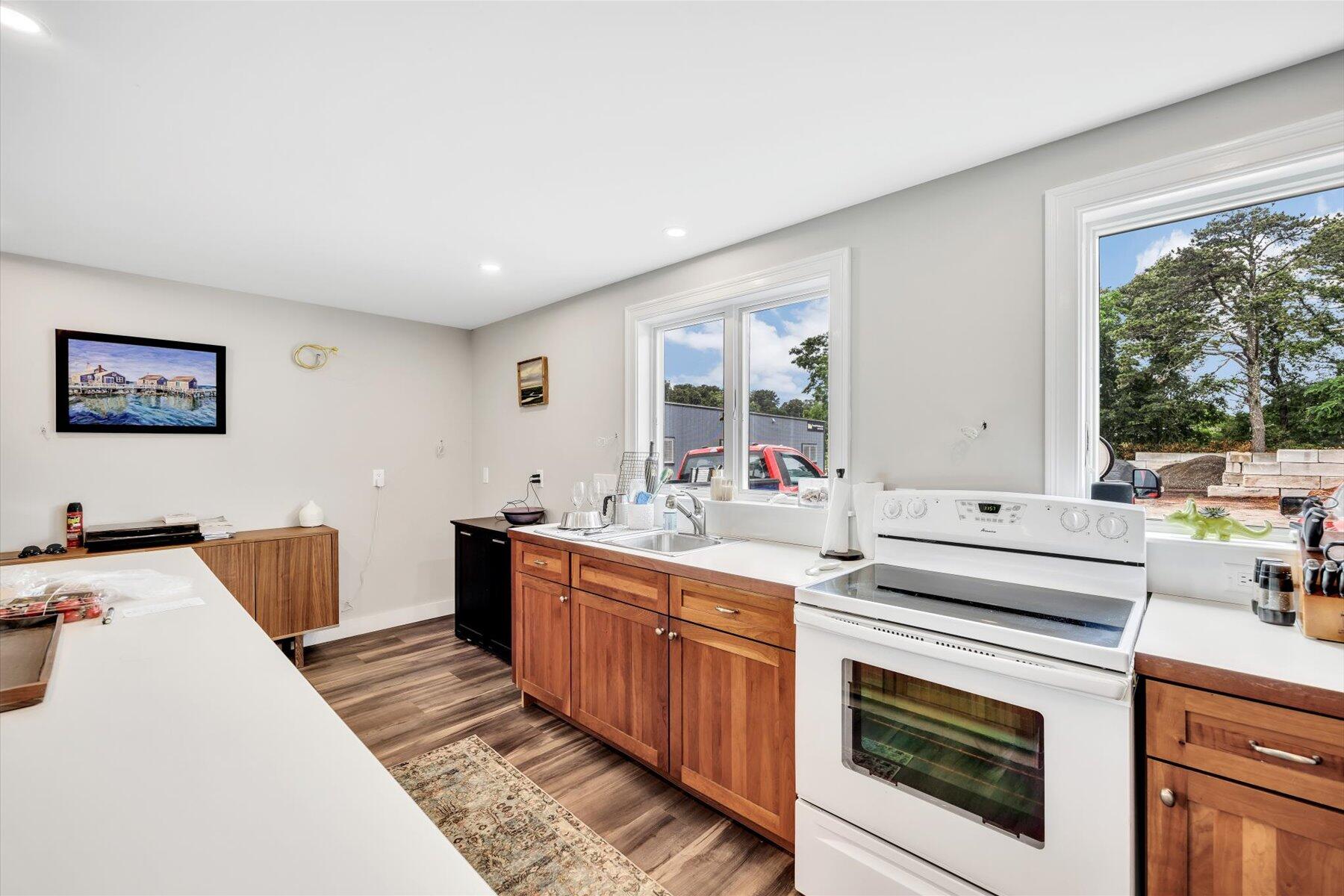 1562 State Hwy Route Eastham, MA 02642 - Photo 20 of 31 a kitchen that has a sink and a stove with wooden floor