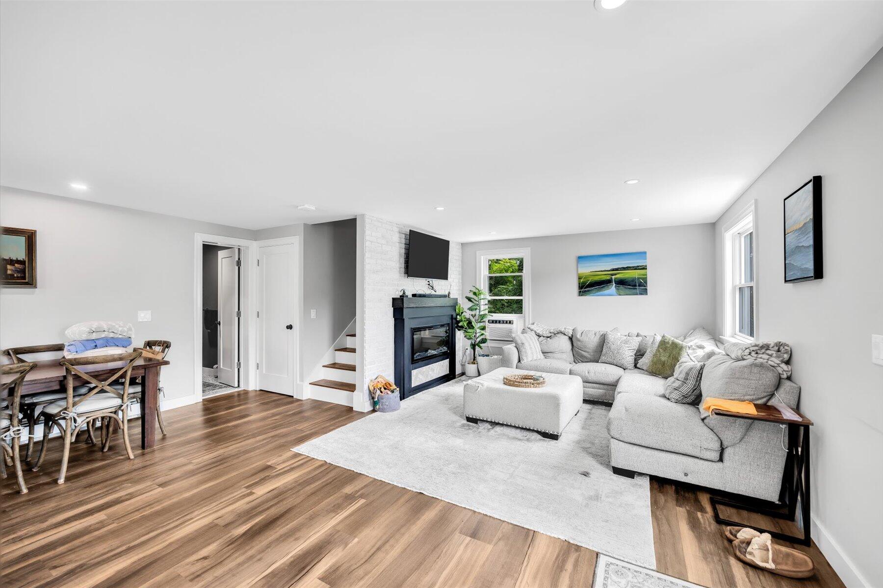 1562 State Hwy Route Eastham, MA 02642 - Photo 22 of 31 a living room with furniture a fireplace and a table