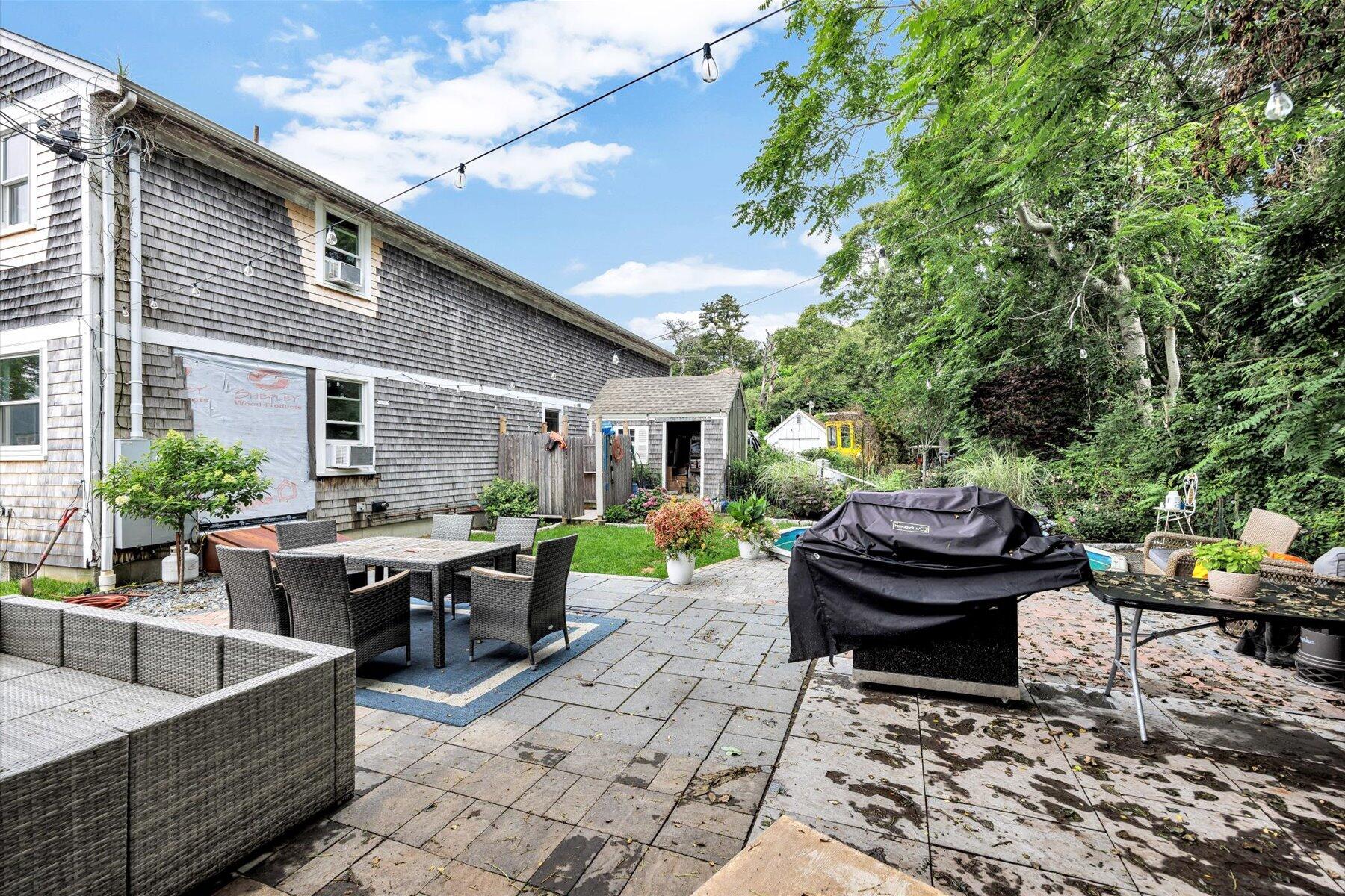 1562 State Hwy Route Eastham, MA 02642 - Photo 6 of 31 a view of a patio with table and chairs potted plants with wooden fence