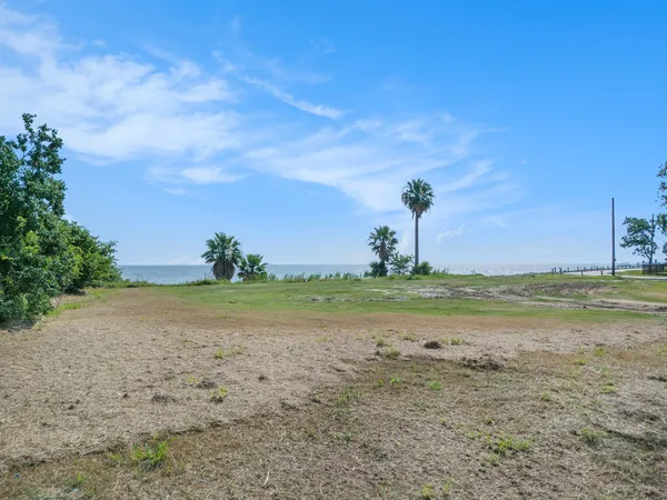 a view of a lake with beach in background