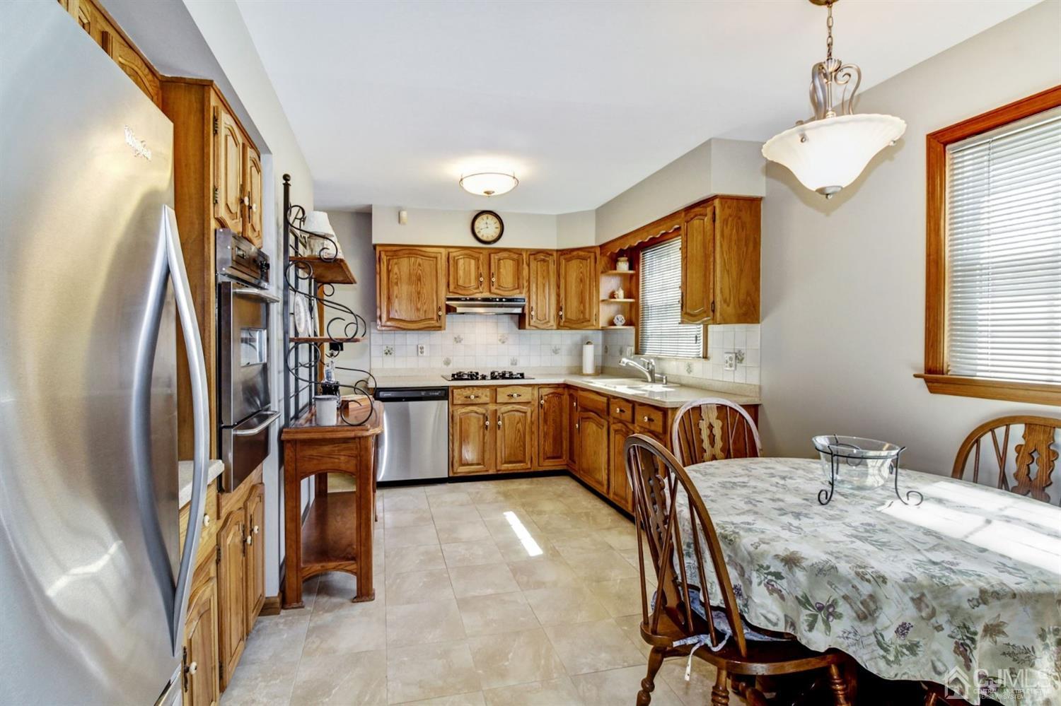35 Rieder Road Edison, NJ 08817 - Photo 6 of 25 a kitchen with stainless steel appliances granite countertop a sink refrigerator dining table and chairs