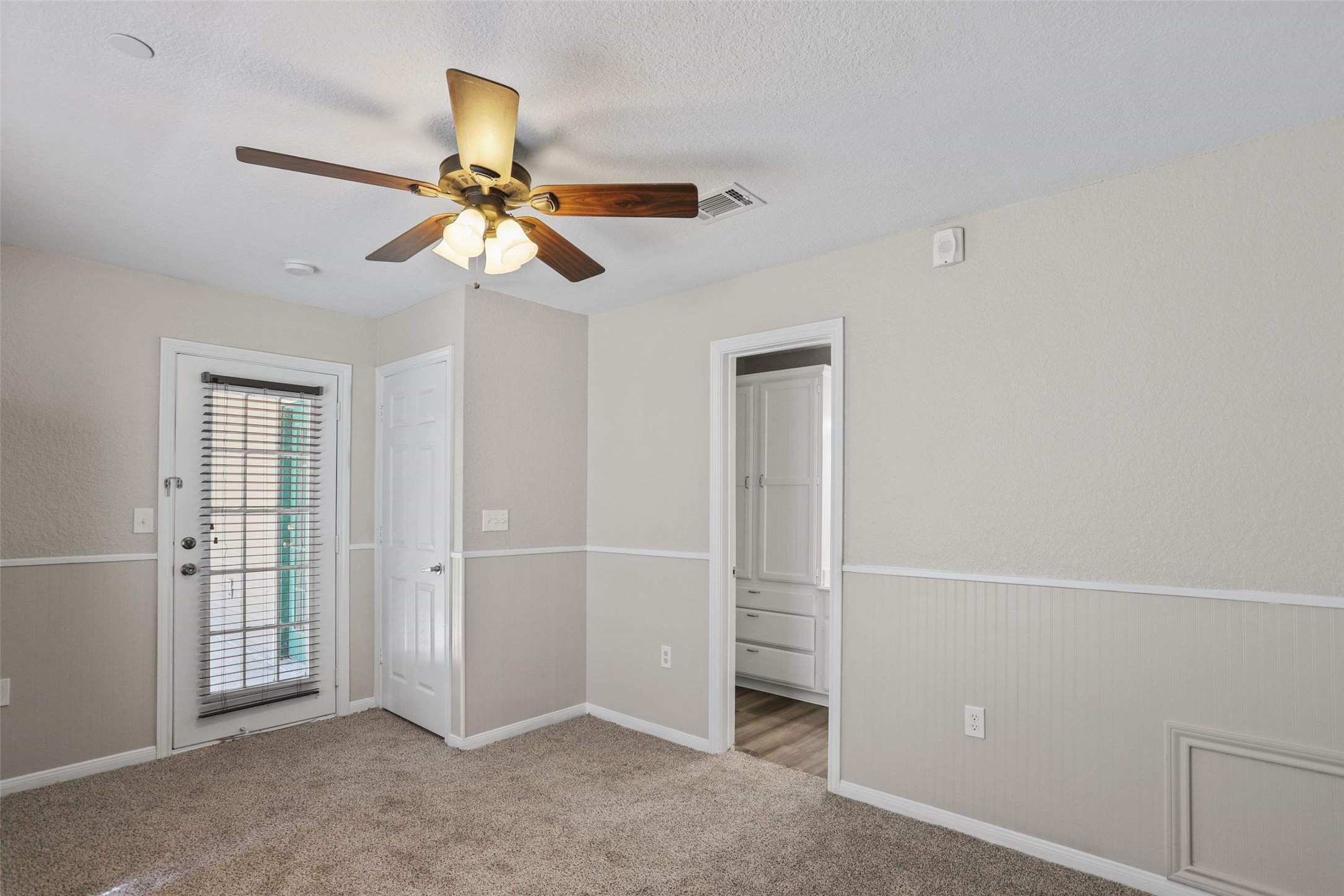 11700 League Line Road, Unit 122 Conroe, TX 77304 - Photo 16 of 25 an empty room with windows and fan
