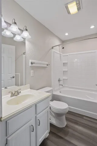 a bathroom with a sink a toilet and a large mirror
