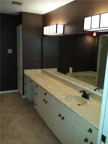 a bathroom with a sink and mirror