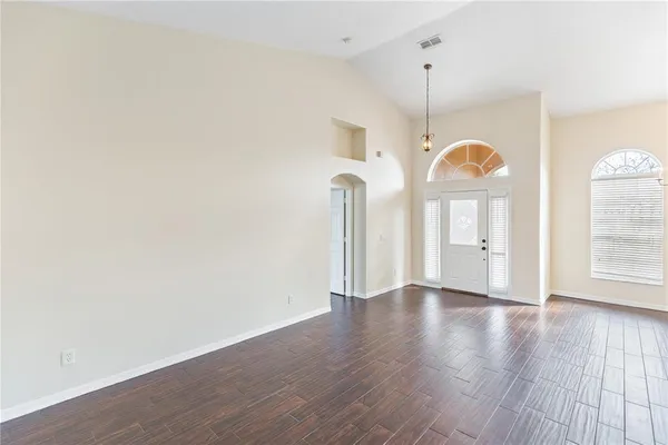 a view of a room with wooden floor and windows