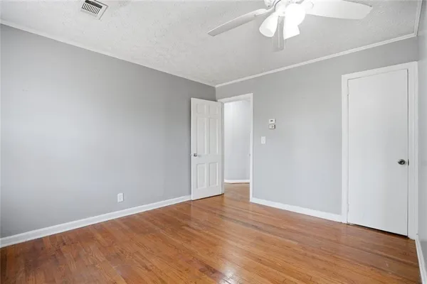 a view of an empty room with wooden floor