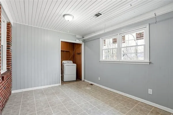 a view of a livingroom with a dishwasher and a window