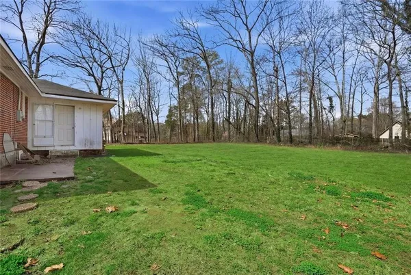a view of a backyard with large trees