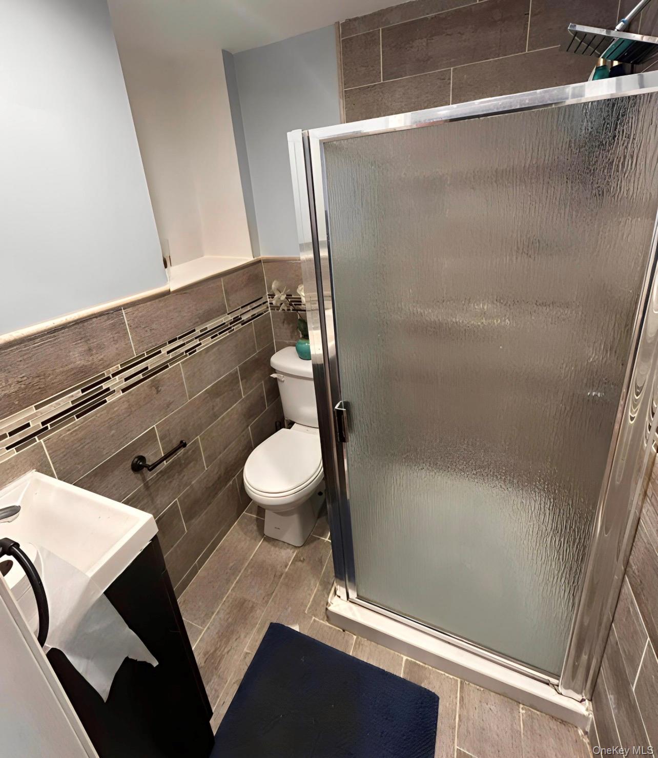 227 Calhoun Avenue Bronx, NY 10465 - Photo 13 of 17 a bathroom with a sink and a mirror