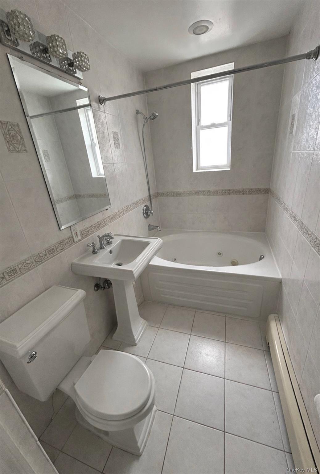 227 Calhoun Avenue Bronx, NY 10465 - Photo 15 of 17 a bathroom with a sink toilet and shower
