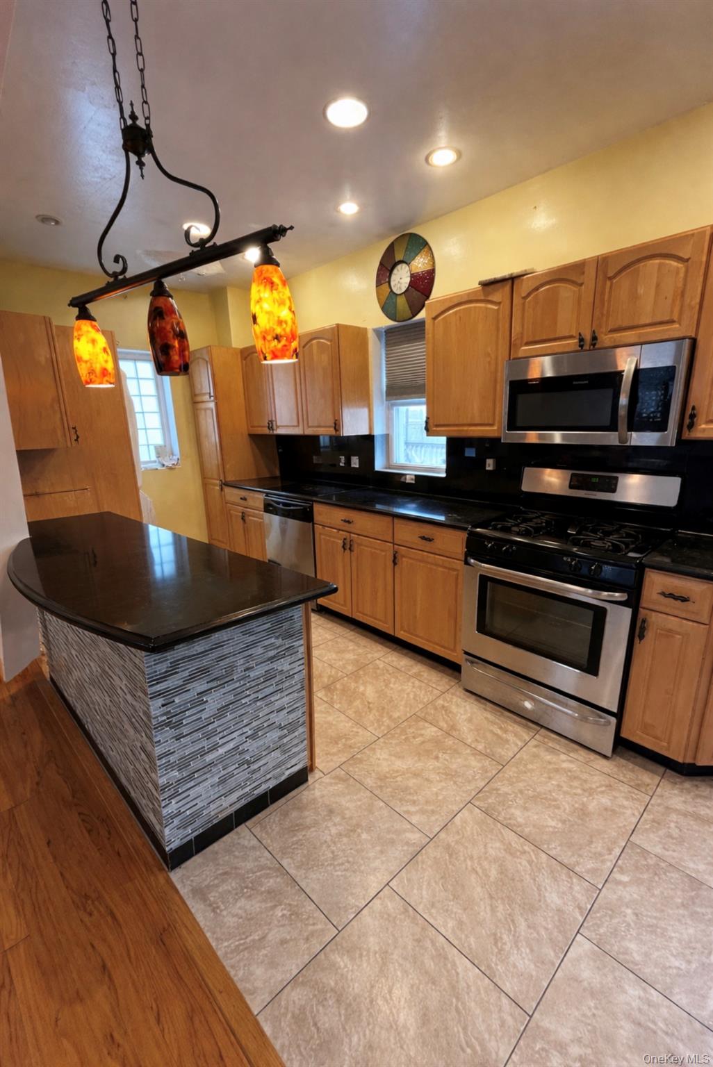 227 Calhoun Avenue Bronx, NY 10465 - Photo 7 of 17 a kitchen with stainless steel appliances granite countertop a sink a stove and a microwave