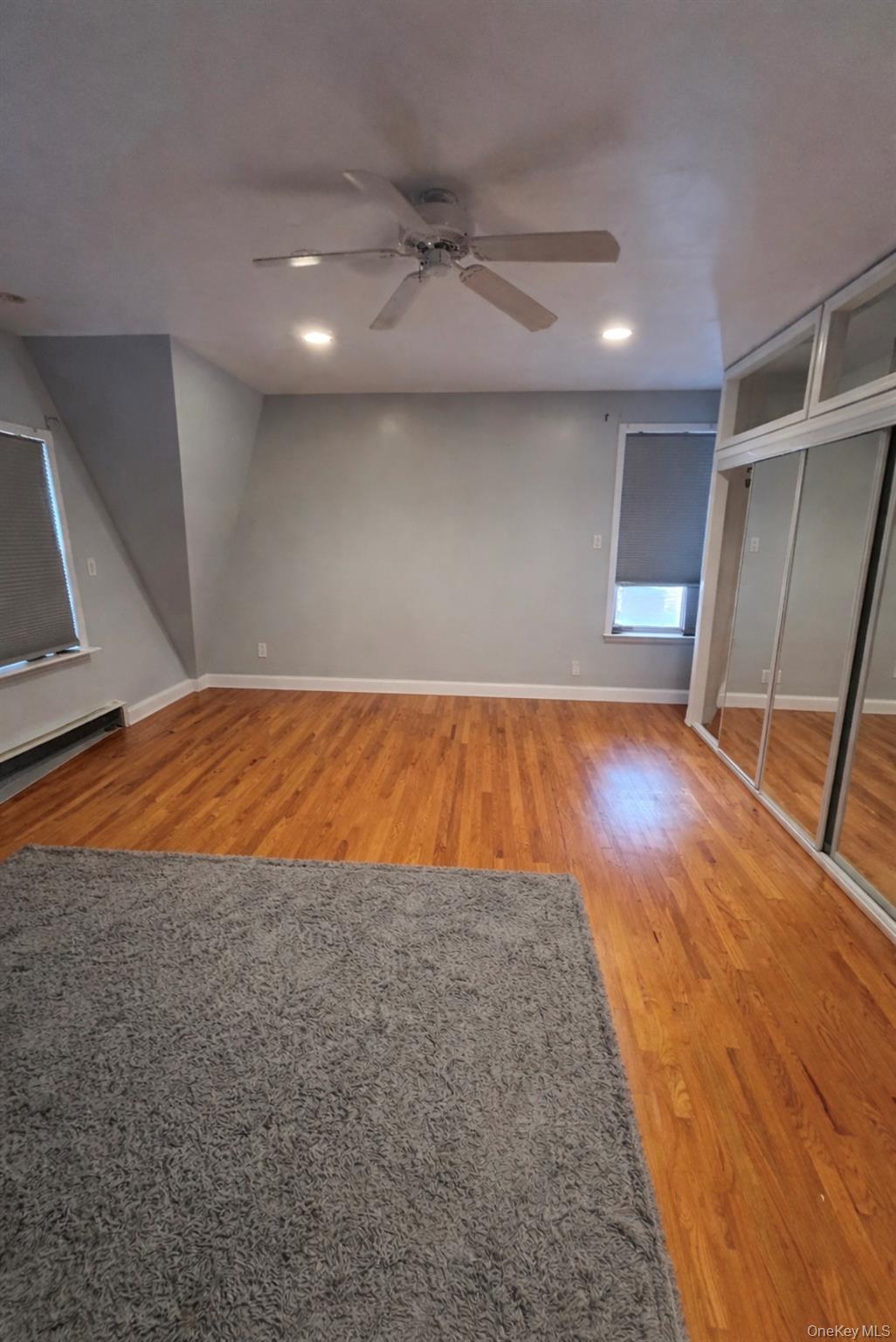 227 Calhoun Avenue Bronx, NY 10465 - Photo 9 of 17 a view of an empty room with wooden floor