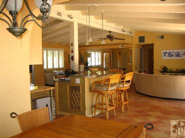 71942 Vista Del Rio Rancho Mirage, CA 92270 - Photo 1 of 1 a living room with furniture a flat screen tv and kitchen view