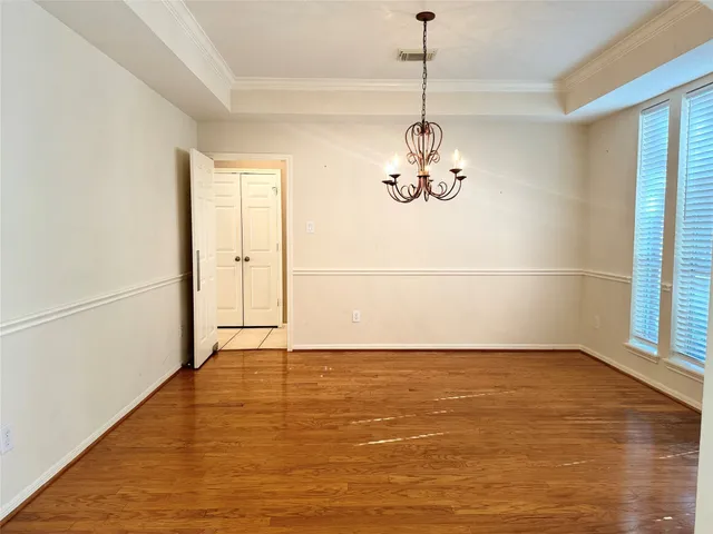 a view of a room with wooden floor fan and window