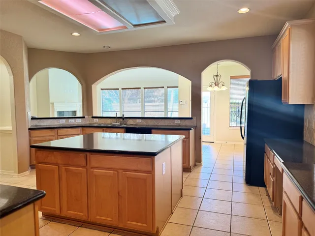 a kitchen with stainless steel appliances granite countertop a sink and cabinets