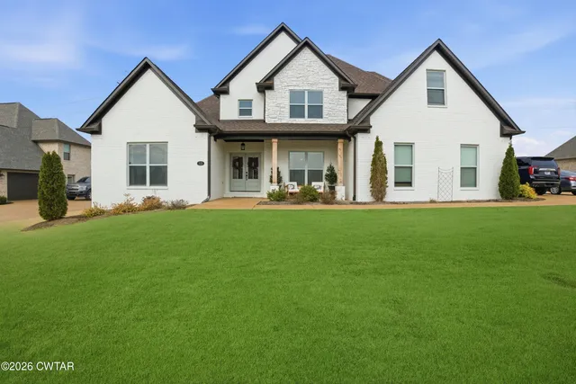 a front view of a house with a yard and porch